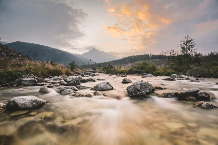 A landscape scene focusing on soft misty flowing river