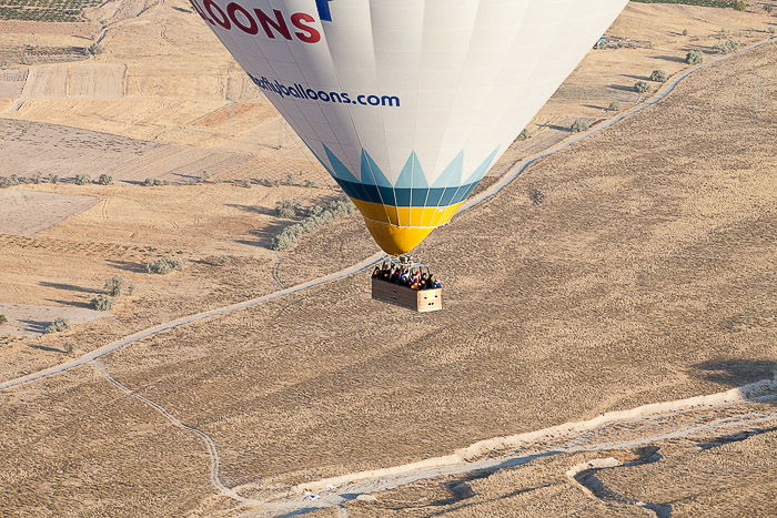 A hot air balloon over a flat grassy landscape