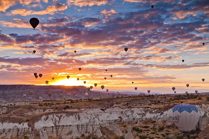 A evening landscape filled with hot air balloons