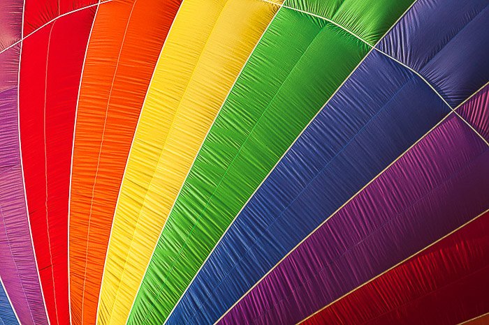 A close up photo of a colorful hot air balloon