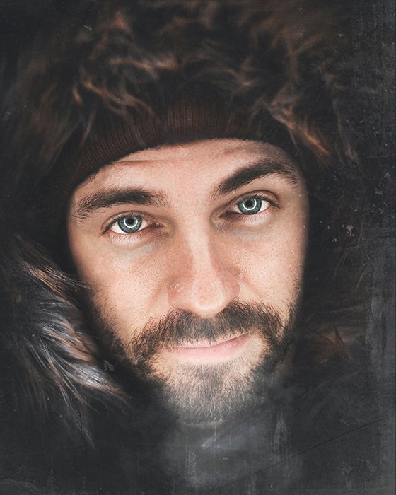 Atmospheric portrait of a bearded man wearing a furry hood and hat - photo assignment tips