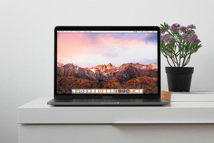 A laptop open on a white desk