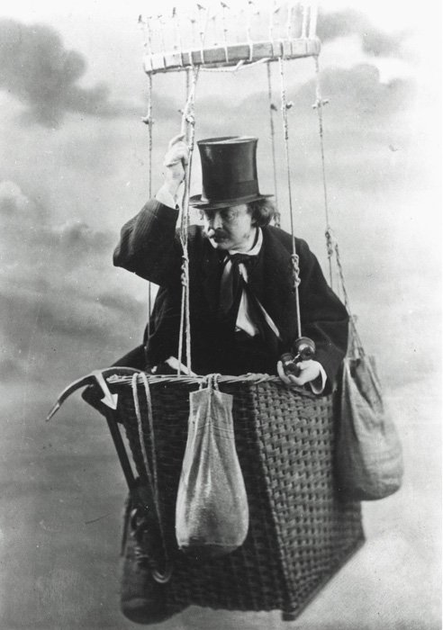 An old black and white portrait of a man in a hot air balloon