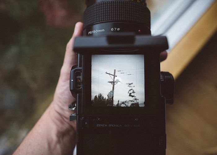 A photographer holding a zenza bronica old film camera