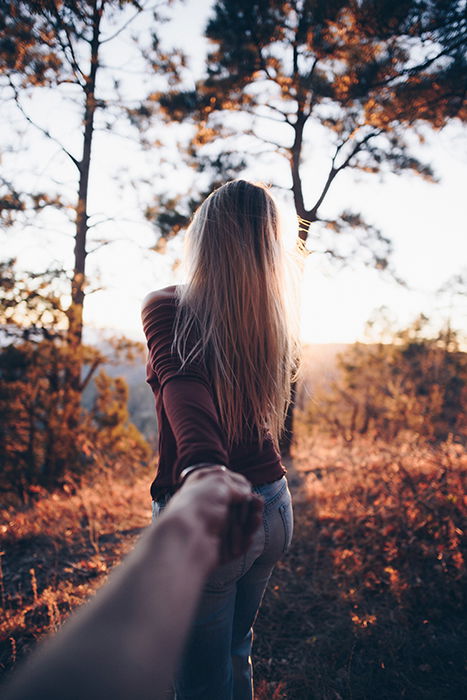 A couple posing in a forest for a Valentine's day photoshoot