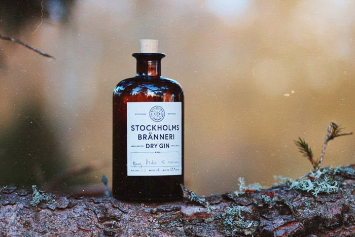 A product photography shot of a bottle of gin on a rustic background