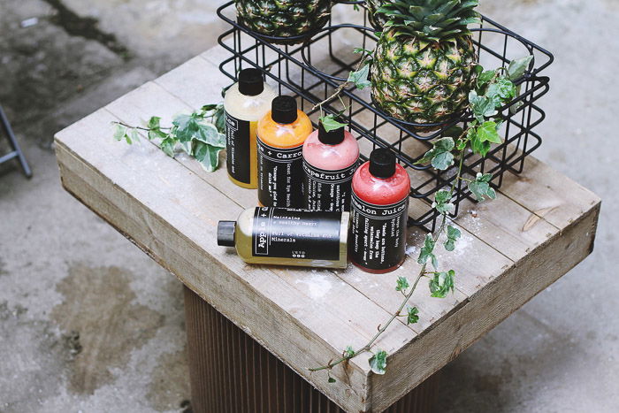 A product photography shot of a cosmetics on a rustic wooden table