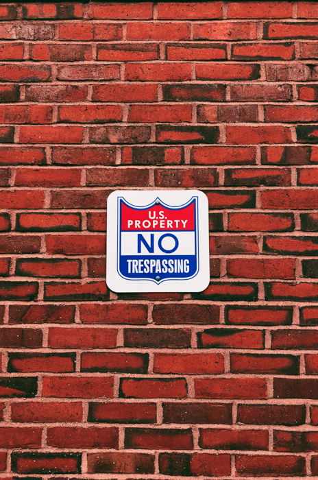 An image of a sign and brick wall