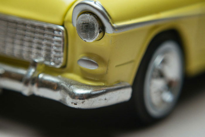 A macro photo of a green car shot using lens reversing rings