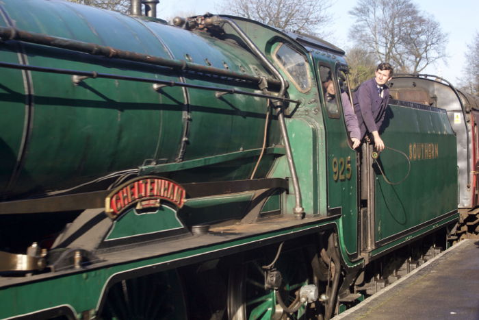 Train drivers looking out from a green train - steam train photography.