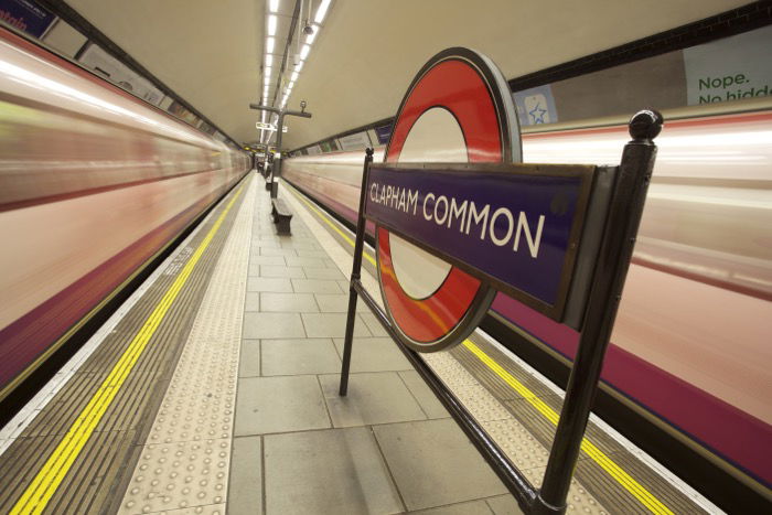 The London Underground sign between two moving trains