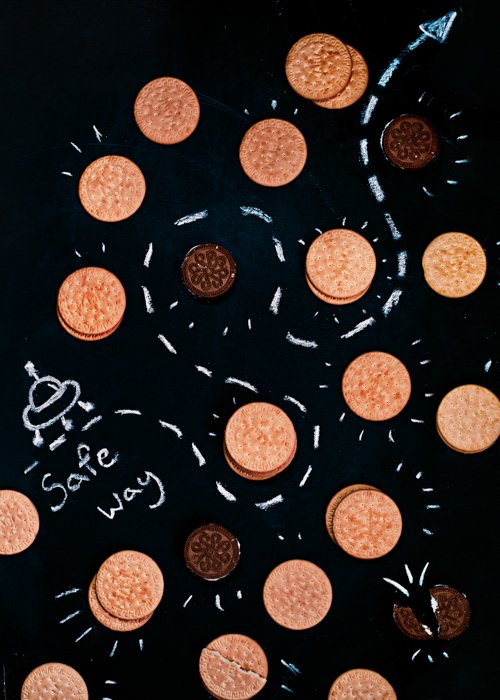 A creative flat lay of cookies on black background - examples of using text in photography