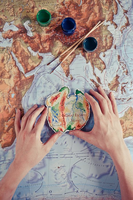 A creative image of a person painting a map of a world - examples of using text in photography