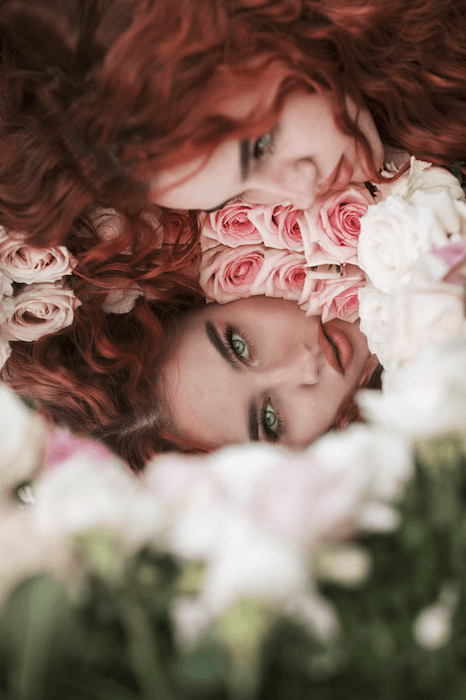 Surreal portrait of a woman flowes and her reflection