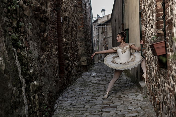 A beautiful ballet photography shot of a female dancer posing outdoors