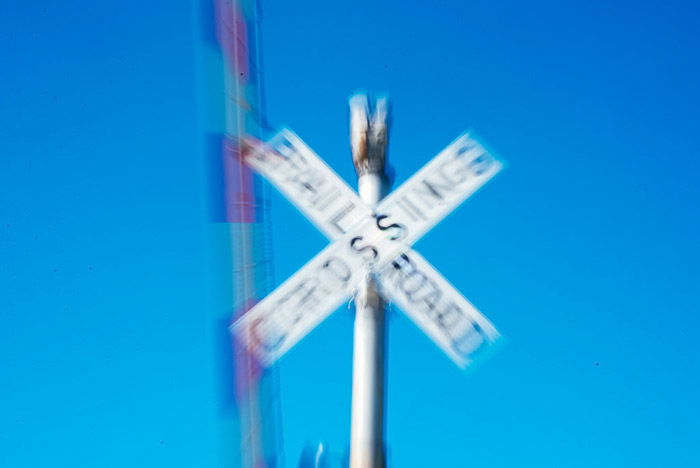 A blurred photo of railway crossing sign - zoom burst photos