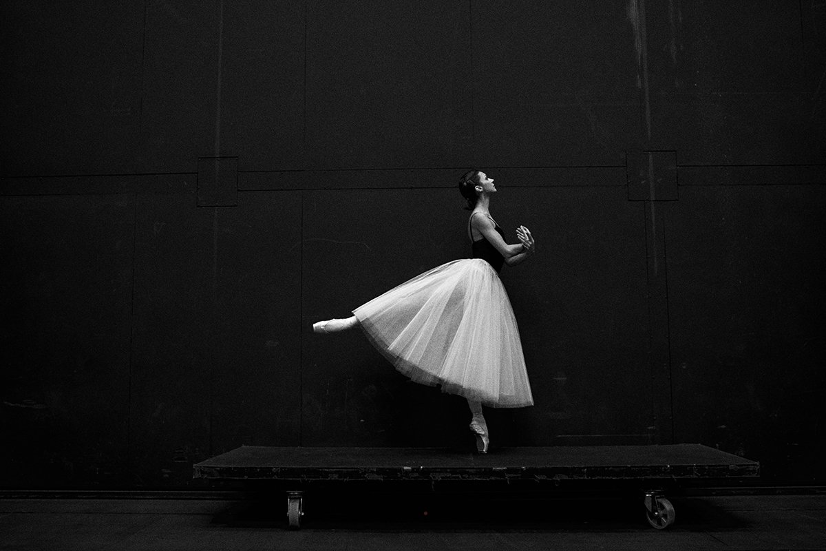 A black-and-white image of a ballerina posing as an example of sports photorgraphy