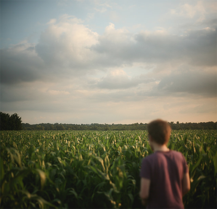 Mysterious fine art portrait of a man in a field