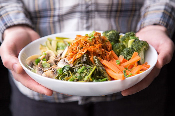 Close up shot of a person holding a colorful sald - food photography inspiration