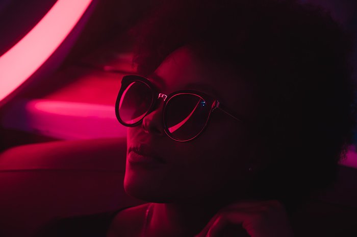 An atmospheric pink neon photography portrait of a female model