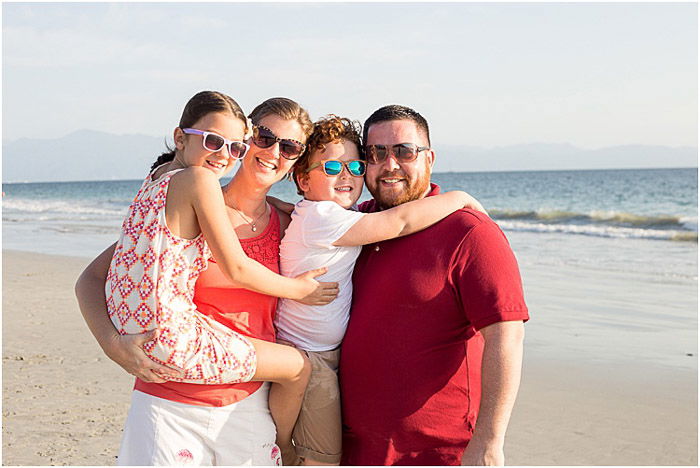 Relaxed portrait of a family posing on a beach - how to photograph people