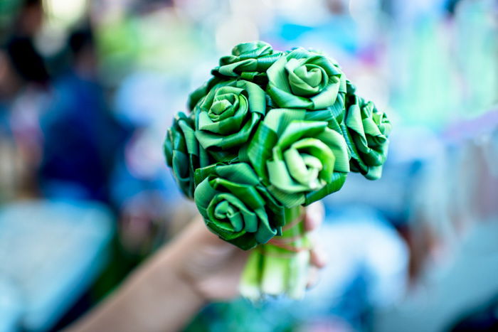 a hand holding a paper bouquet