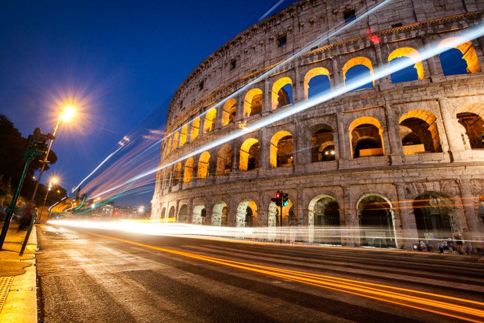 A stunning photo of car light trails outside the Colosseum at night