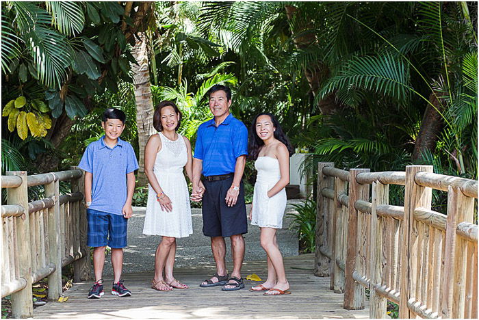 A family of four posing outdoors - take good photos of people