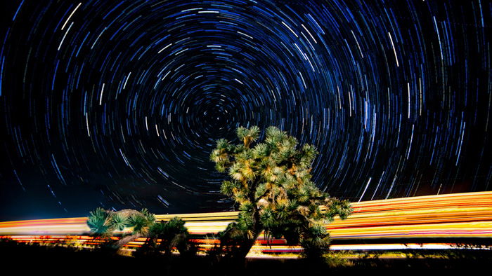 A stunning time lapse shot of the night sky over a landscape, shot using a time lapse calculator 