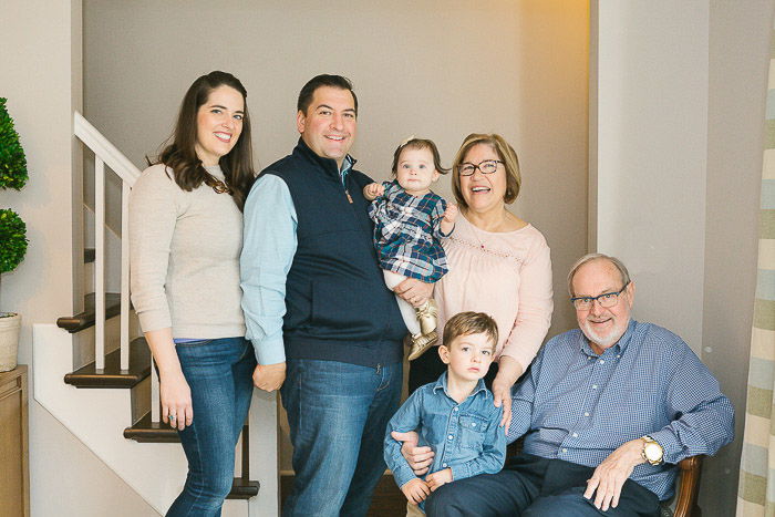 A large group posing for a family portrait indoors 