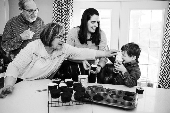 Monochrome shot of a family group posing for a family portrait indoors 