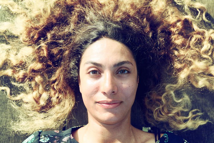 An overhead portrait of a female model with curly brown hair