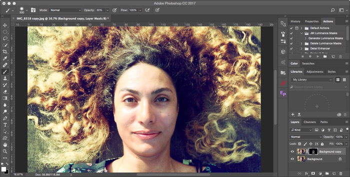 Editing an overhead portrait of a female model with curly brown hair for soft focus effect