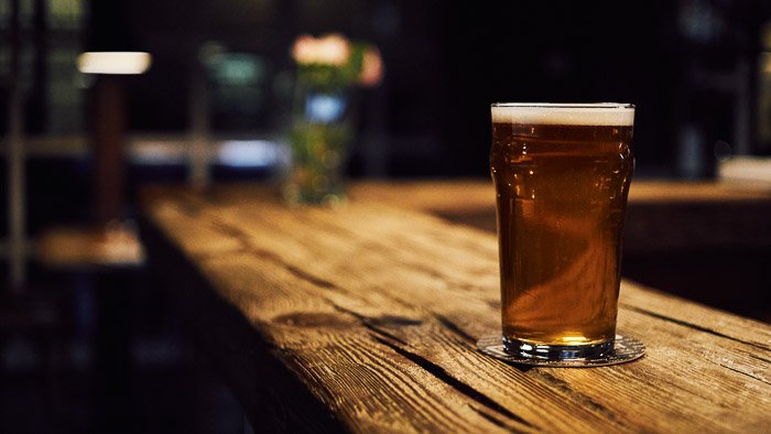 A photo of beer on a bar counter - beer photography tips