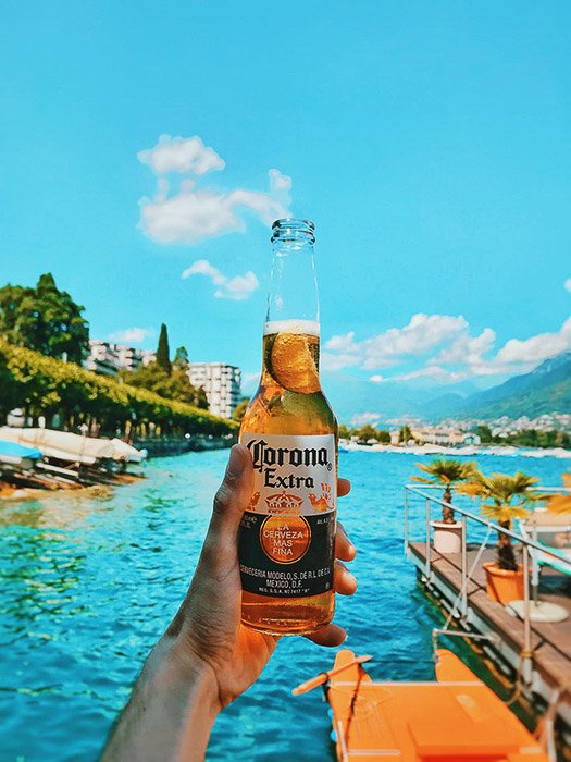 A bottle of corona beer shot against a tropical background - beer photos