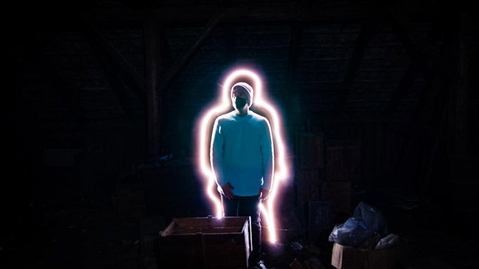 A creative portarit of a man with a line of light painting surroundeing him, shot using LED light painting tools