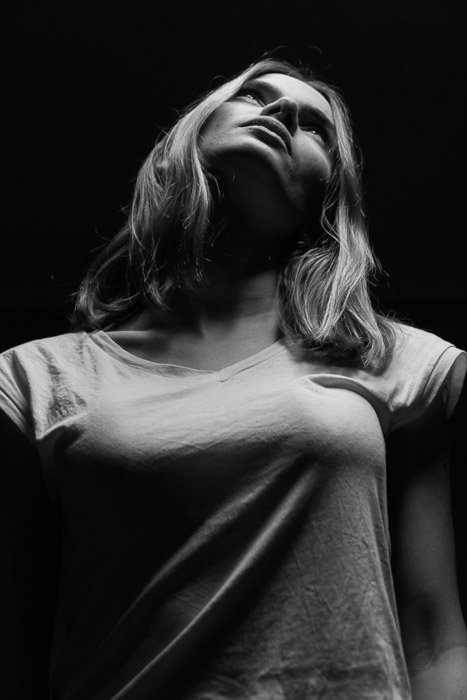 Atmospheric photo of a female model using dramatic portrait lighting 
