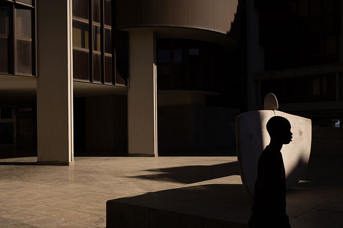 Atmospheric portrait of a silhouette of a person in a shadowy interior - fine art photography mistakes