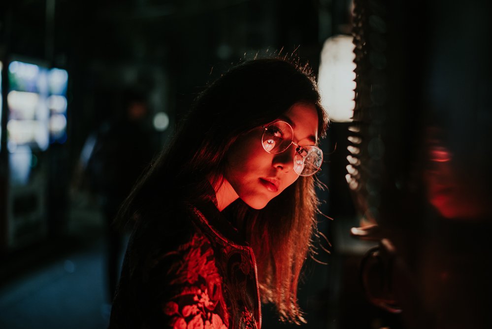 Street photography portrait at night with red lighting