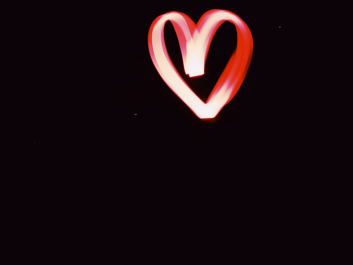 Red heart shaped light painting shot at night using LED light painting tools