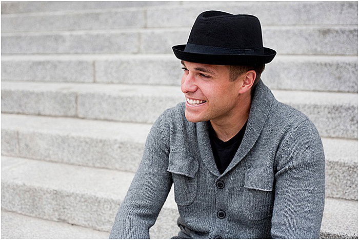 A smiling male model posing outdoors - emotional photography