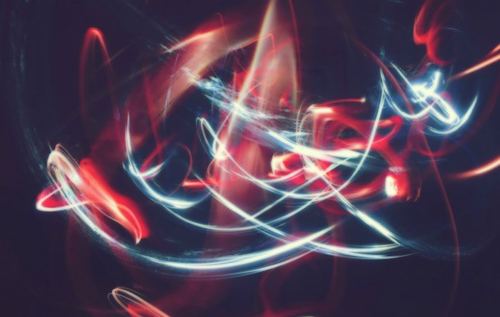 Cool abstract photography featuring streaks of red and white light against black background 