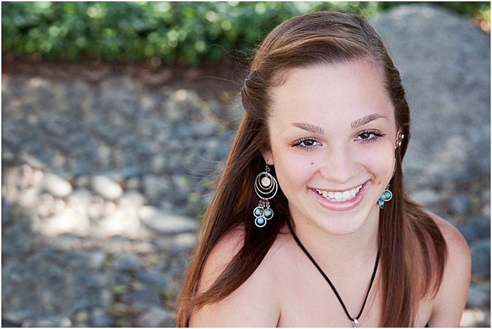 A portrait of a young woman posing outdoors - teen photography