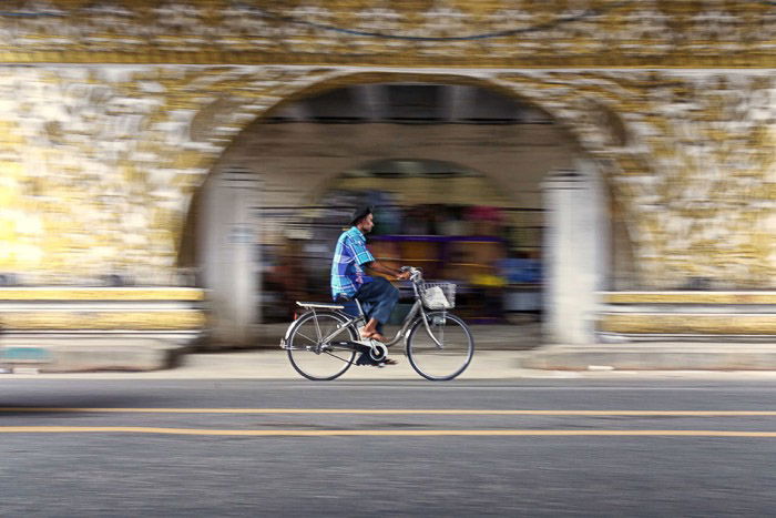 A cyclist passing under the bridge with creative motion blur using slow shutter speed