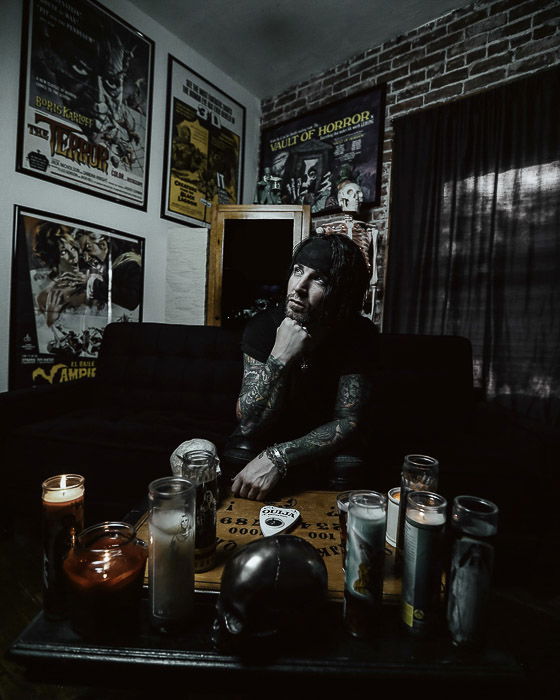 Dark and moody portrait of a man in an interior setting shot with studio lights