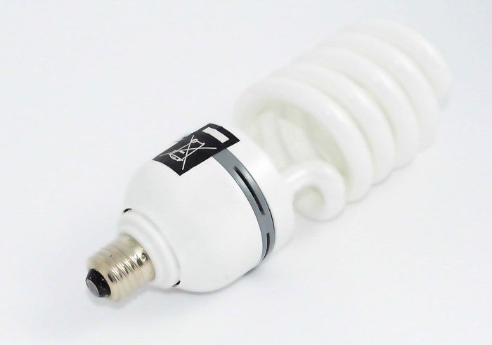 A fluorescent light bulb on white background - types of lights 