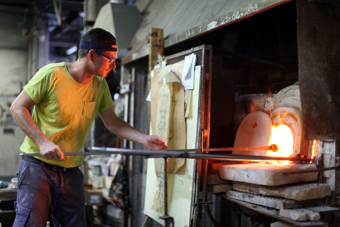 A man firing glass at a workshop in Murano - Venice pictures