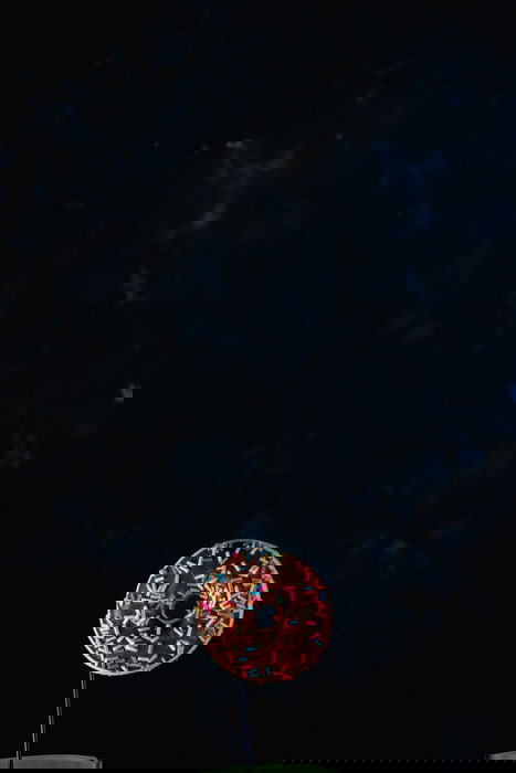 A donut on dark background - setup for creating chocolate splash photography