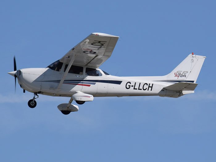 A Cessna 172 Skyhawk aircraft in mid flight - abstract aerial landscape photos