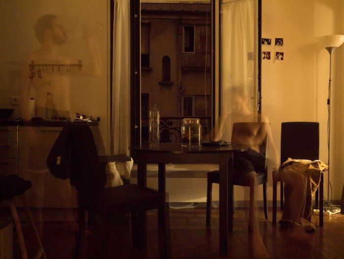A conceptual photo of a room with a blurred image of a man
